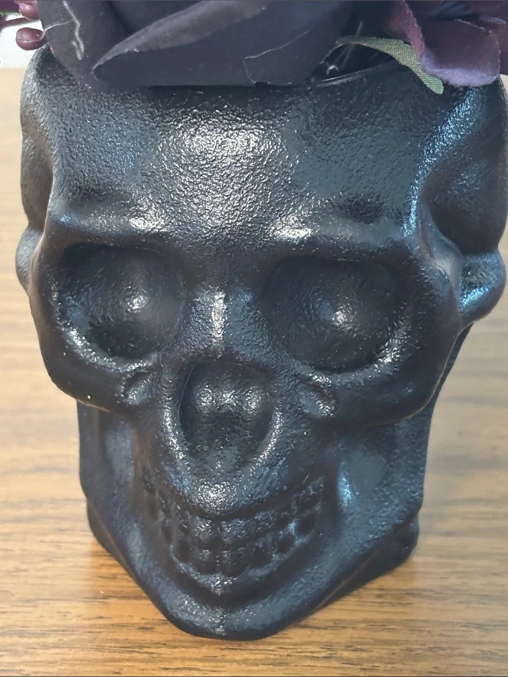 Black Skull Vase with Dark Purple Floral Arrangement